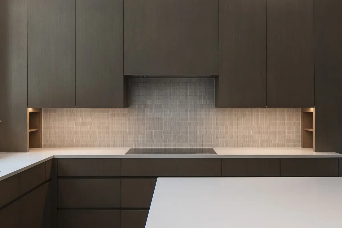 Kitchen elevation straight on, cooktop under a pale tile wall between two lit niches