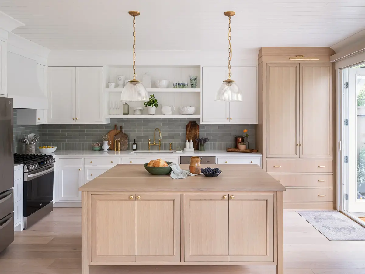 Kitchen with a freestanding wood island, open shelving and a glazed door to the garden