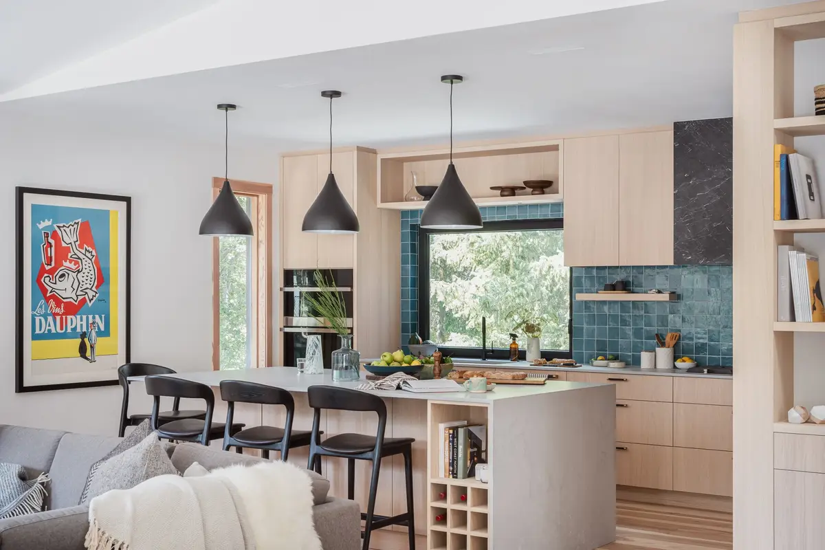 Living and kitchen from the sofa, pendants over the island and a framed poster