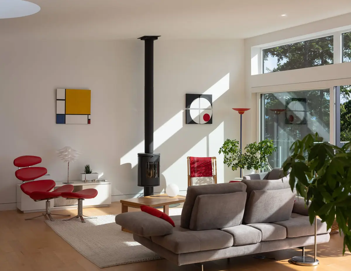Living room elevation, the stove between a grid painting and a circle panel
