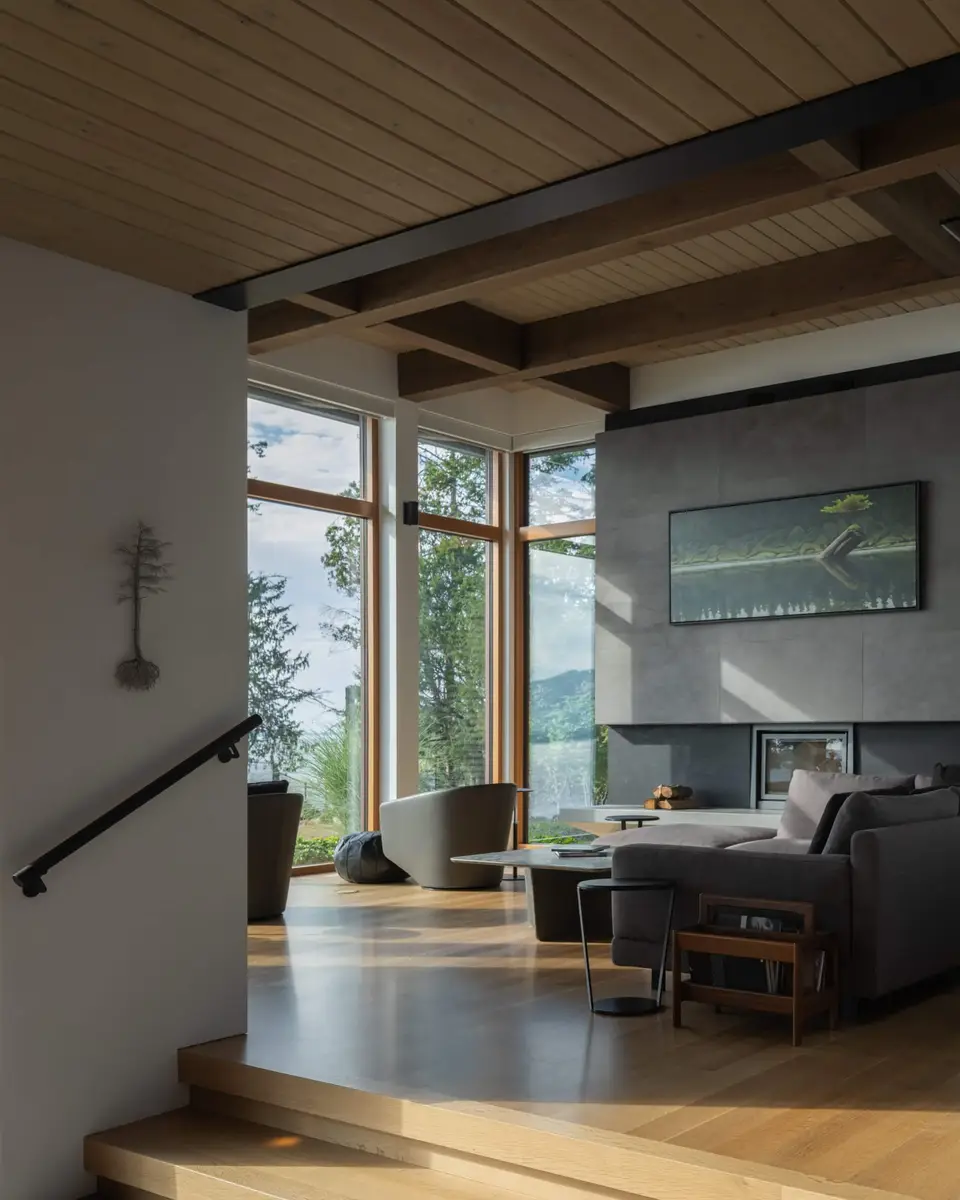 Living room from the stair, a long framed painting on the grey fireplace wall