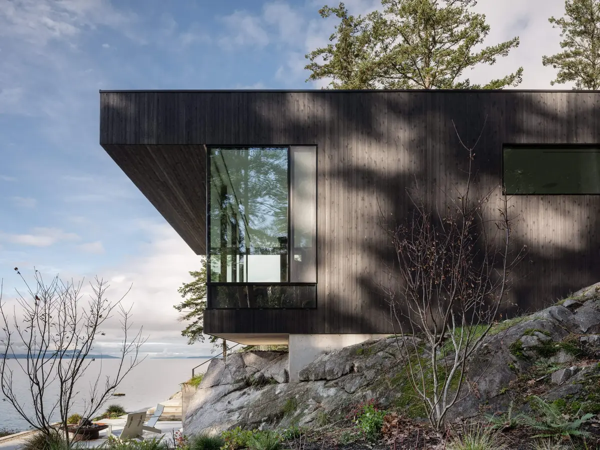 The Perch, Sunshine Coast, a dark clad corner projecting out over rock, the sea and low cloud beyond
