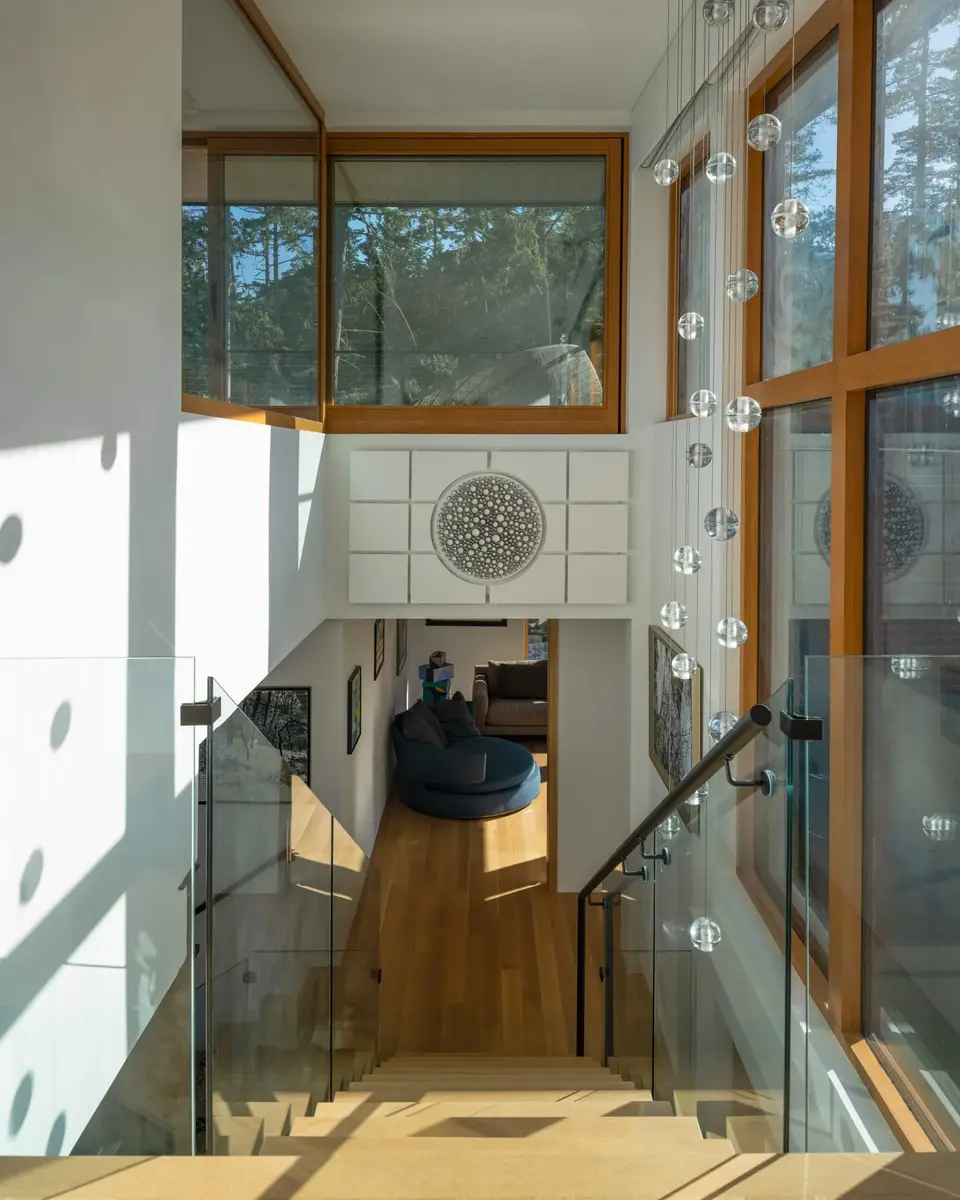 Looking down the stair past a string of glass pendants to the hall below