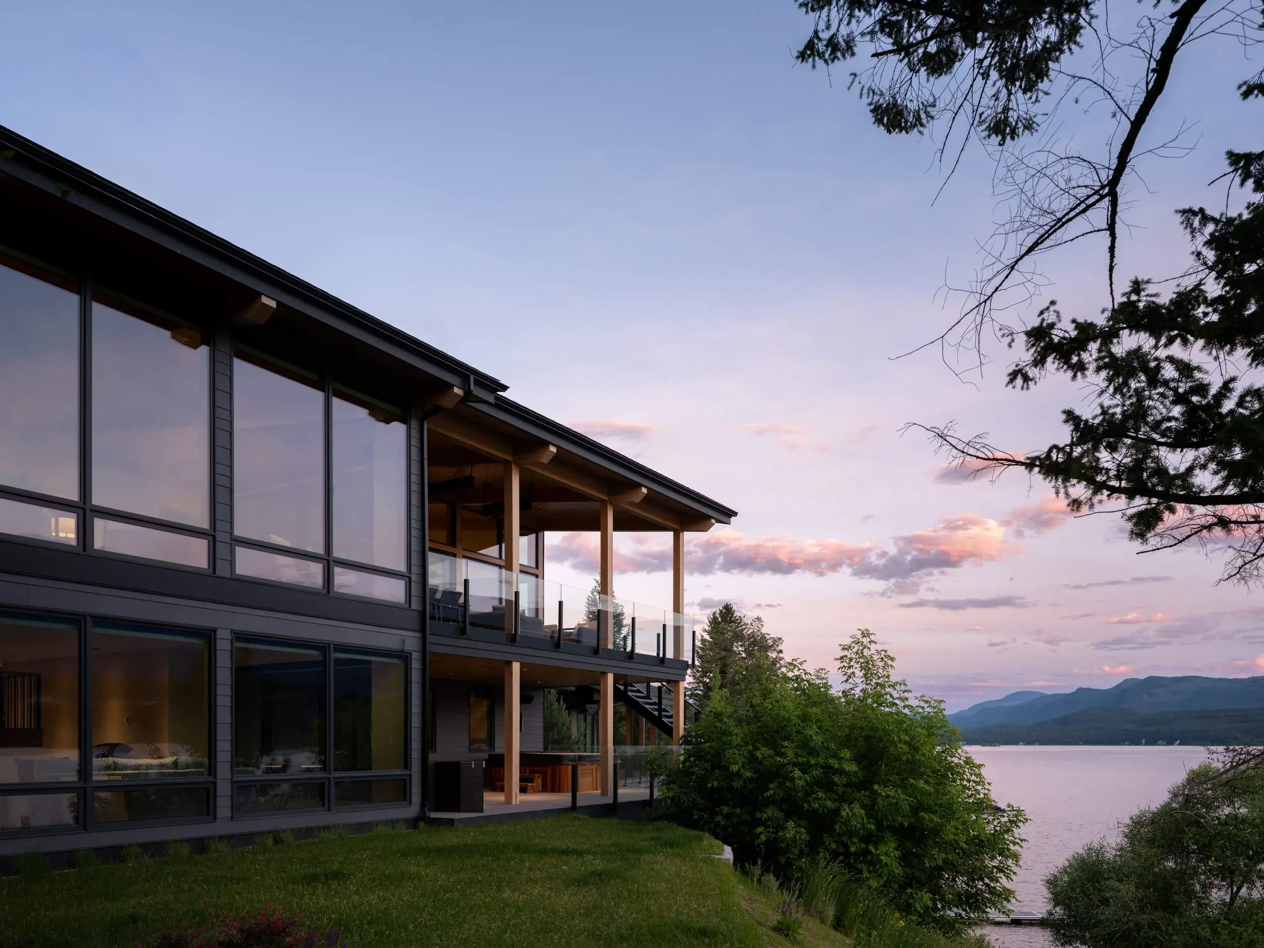 Schmidt Residence glass elevation at dusk over the lake