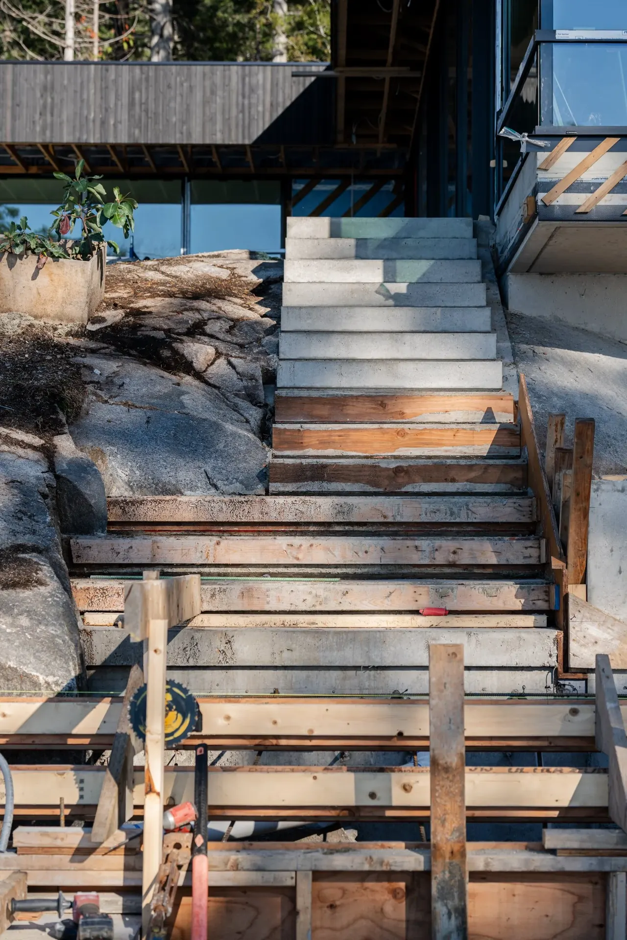 Concrete steps under construction against the rock, wood formwork still in place