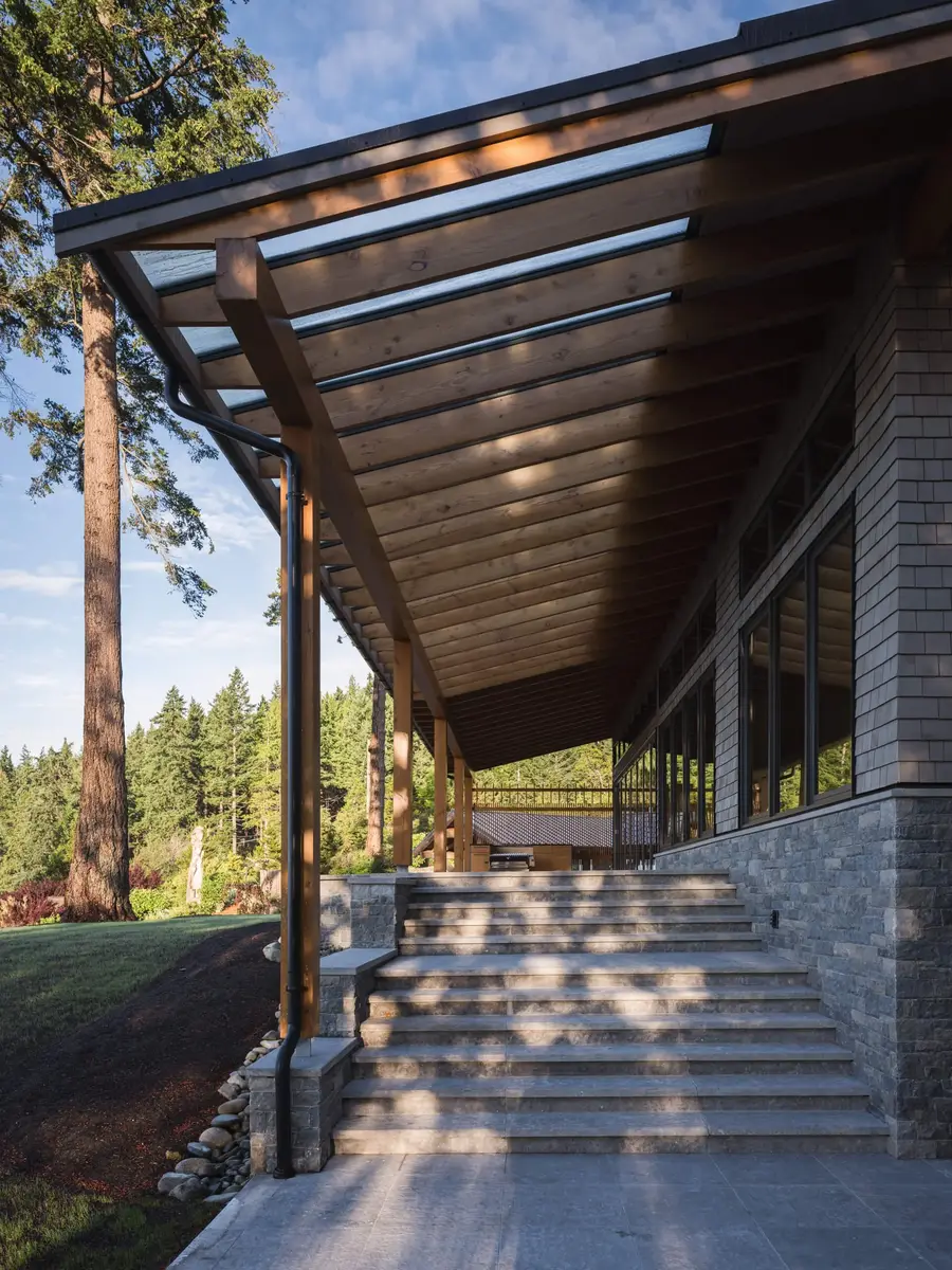 Wide stone steps rising beside a covered walk, its roof carrying a strip of glazing