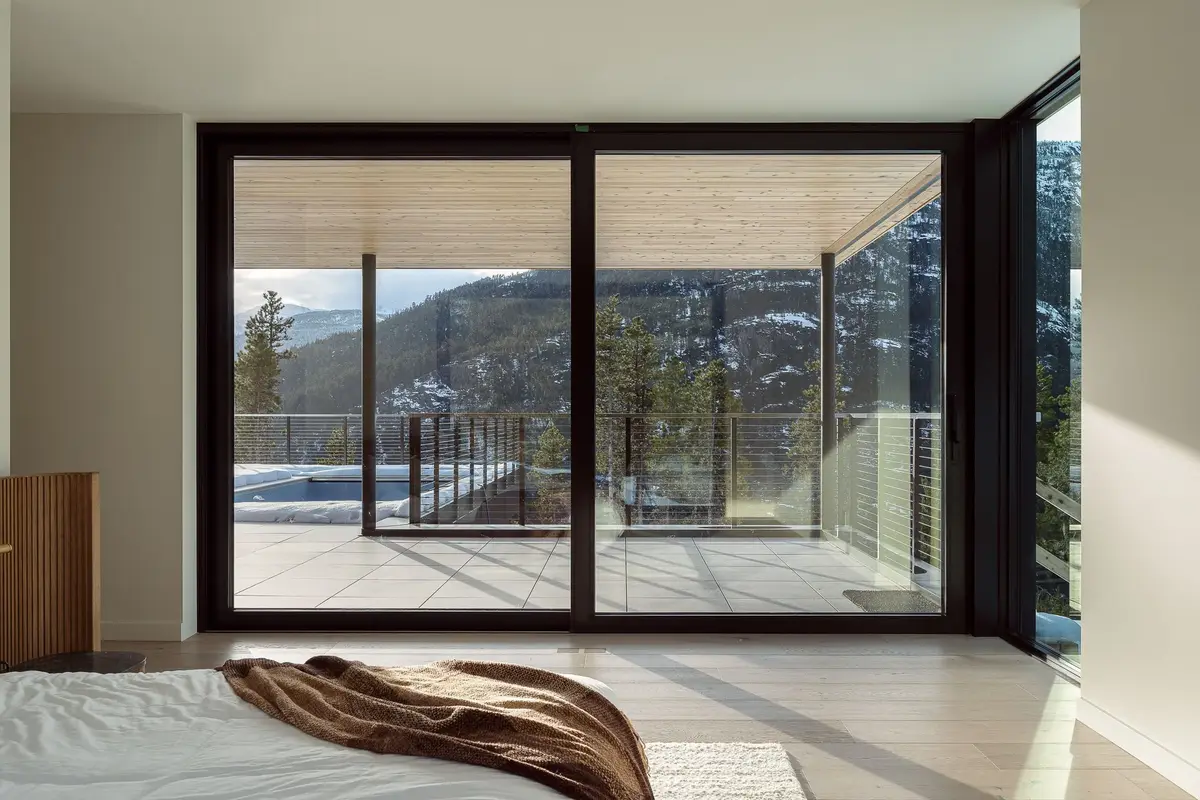 Primary bedroom with sliding glass the width of the room, opening to the terrace