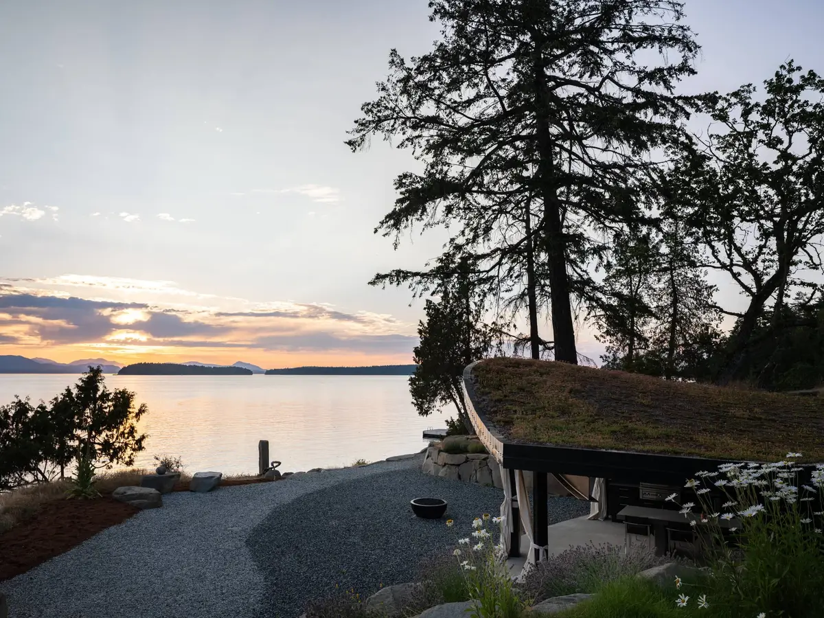 The shore path at sunset, the pavilion roof curving in at the right edge