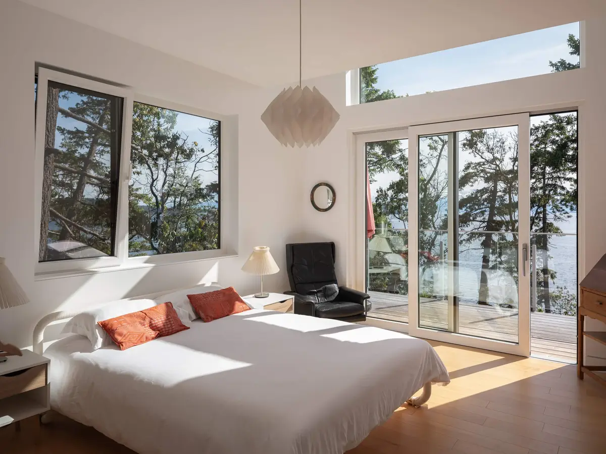 Bedroom with sliding doors to the deck, a paper pendant above the bed