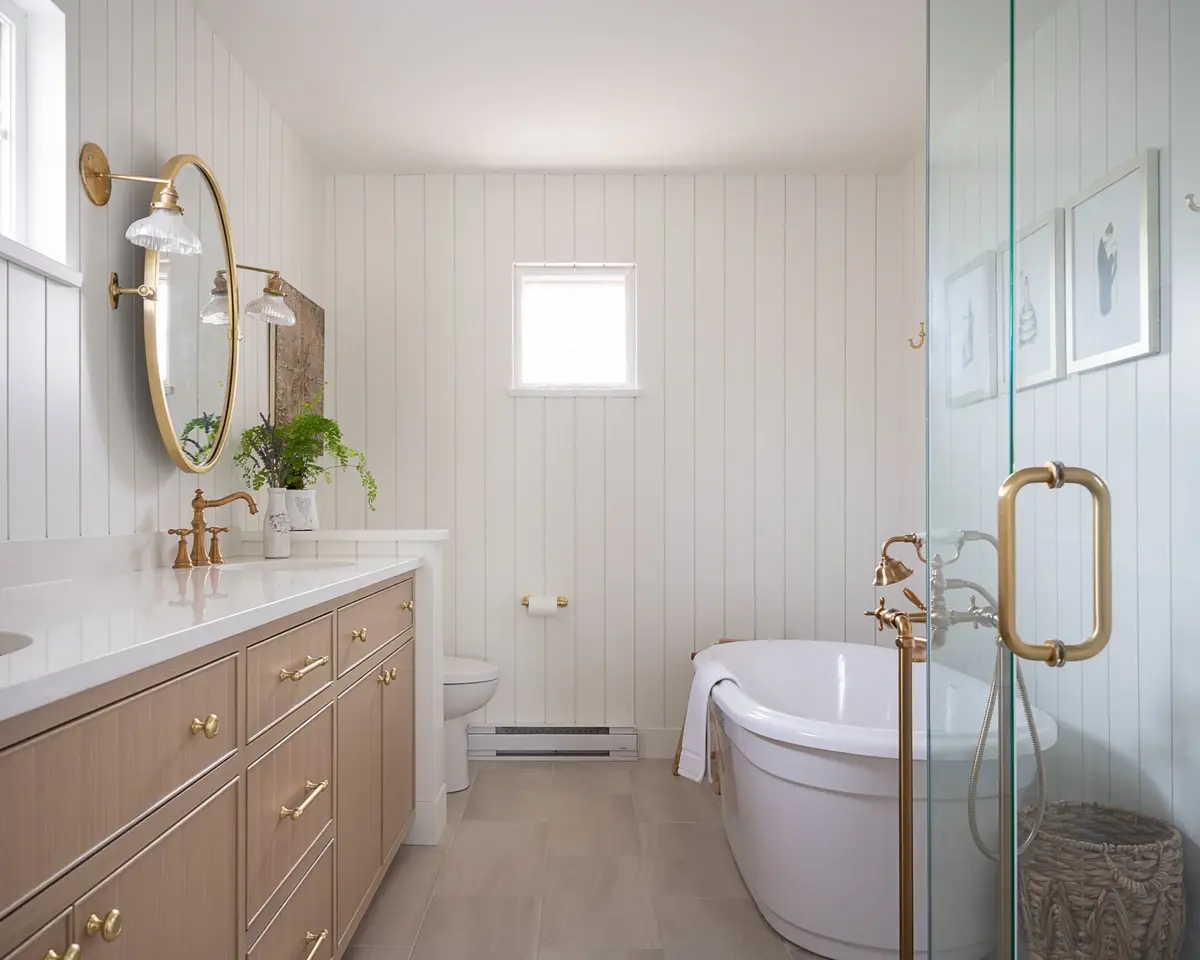 Bathroom with a double vanity, a freestanding tub and a glass shower door