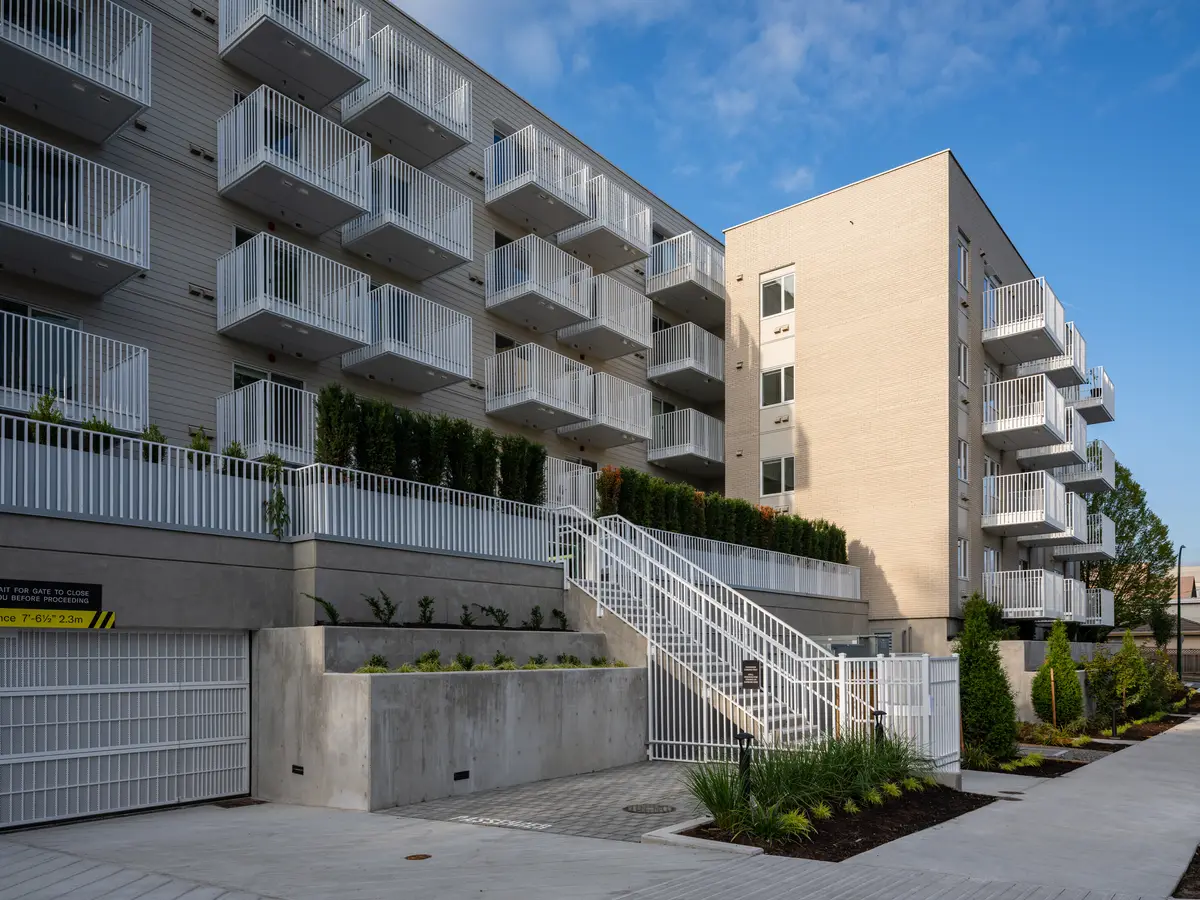 An angled view of the open stair, planter beds and the pale end wall