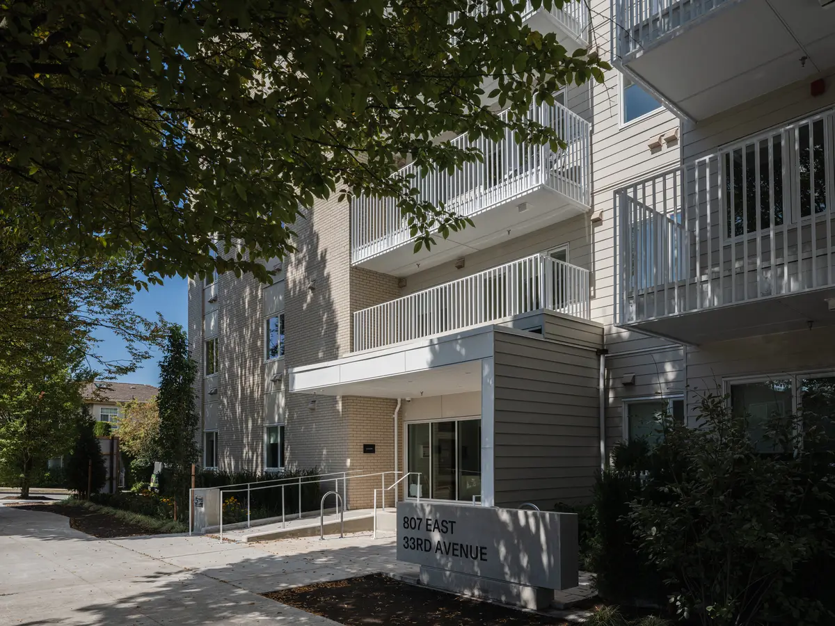The entry canopy, the address sign, and balconies above