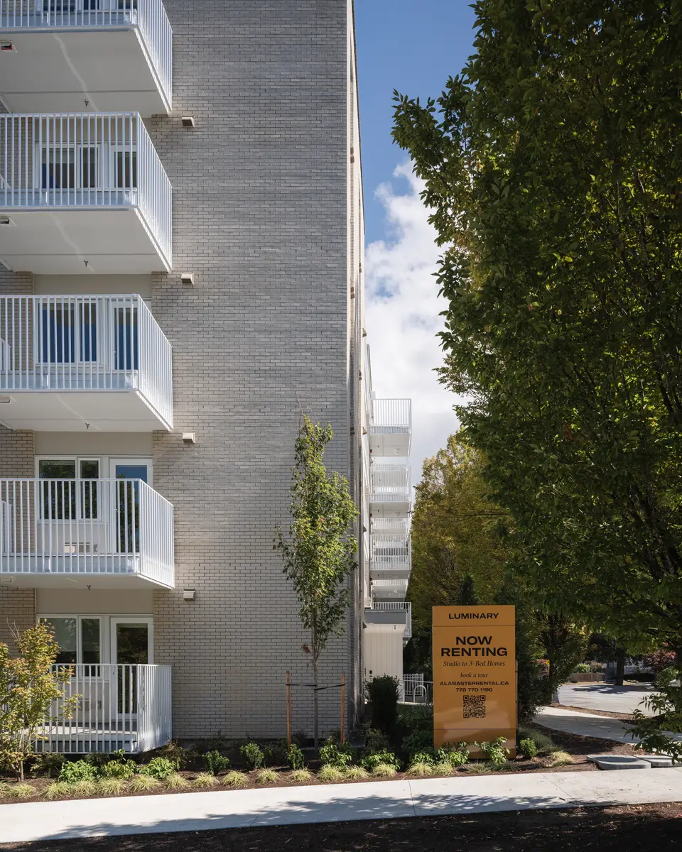 The brick corner, balconies, and the leasing sign