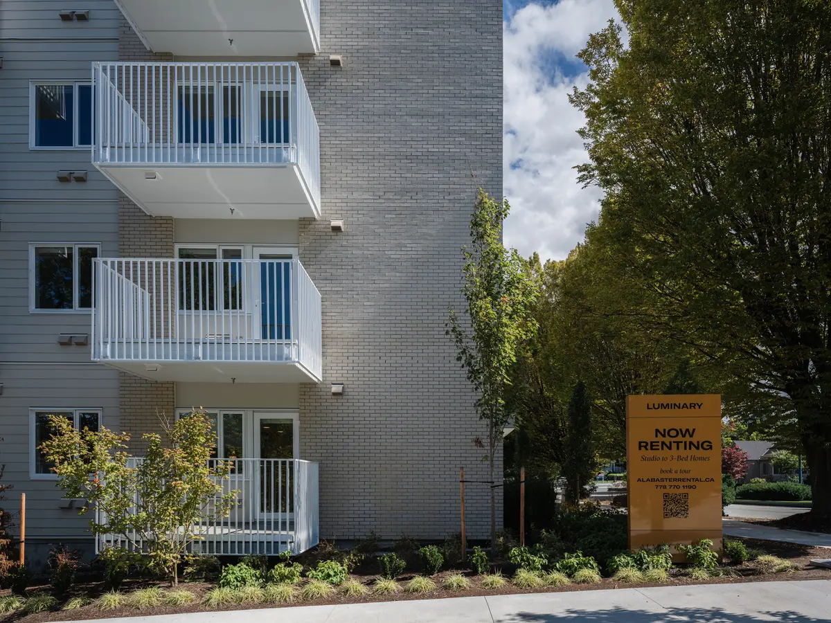 The side elevation, balconies stepping back beside a tree