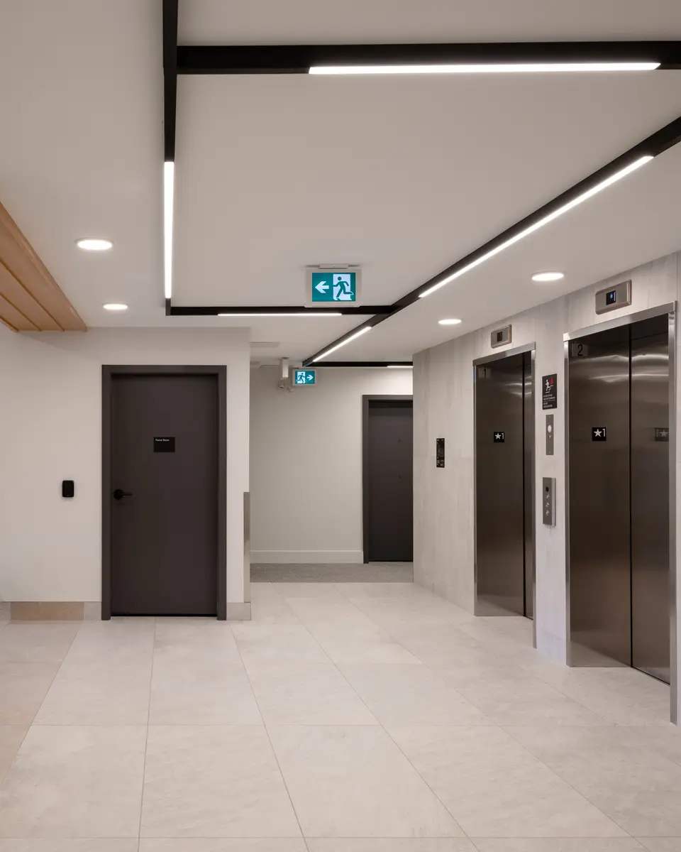 Elevator doors in a stone-tiled lobby