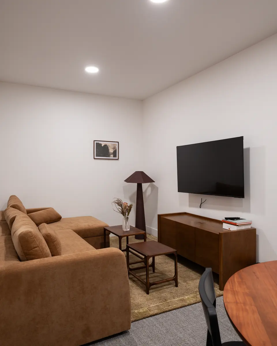 The suite living room, a sofa, television, and a floor lamp