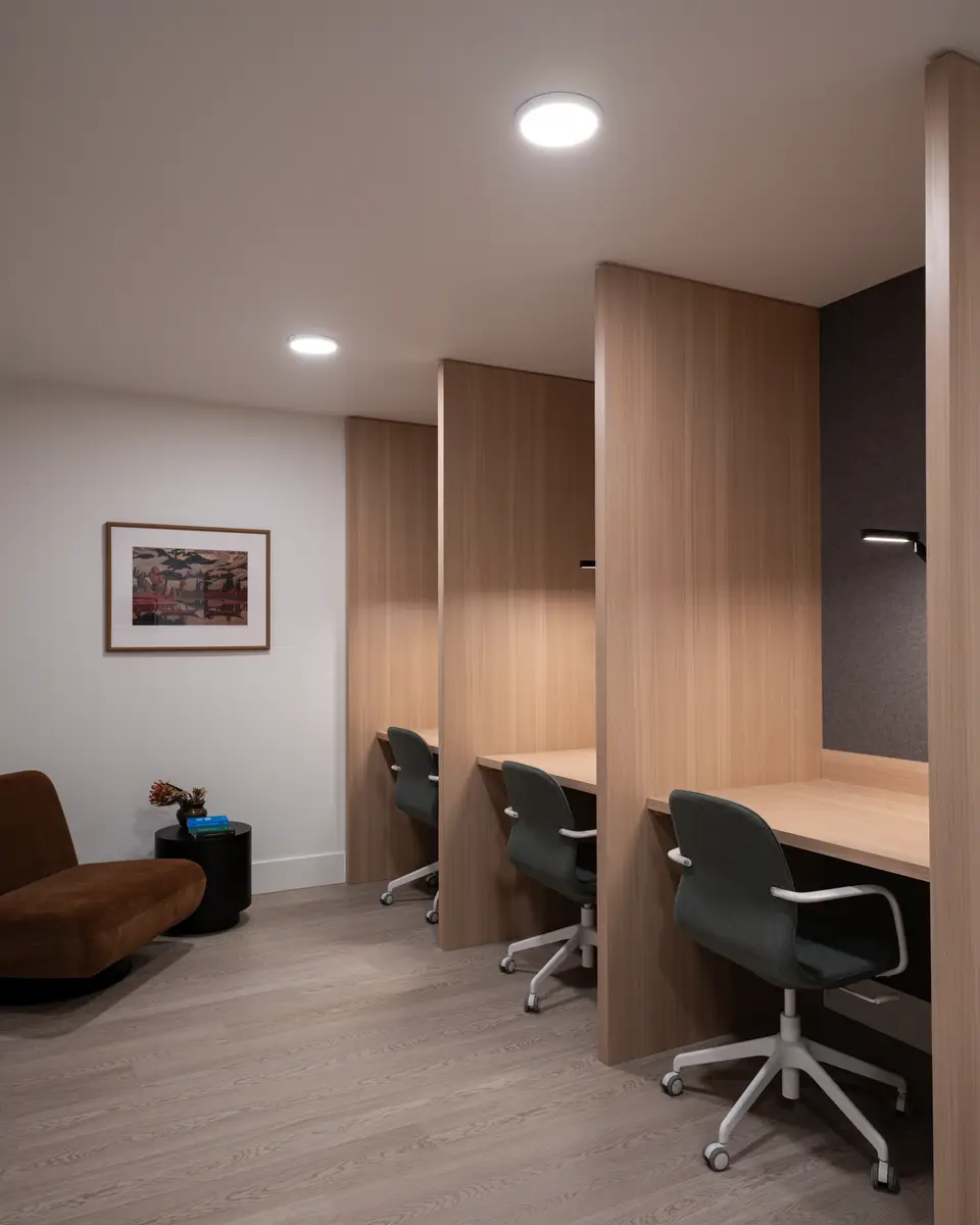 Two desks in wood alcoves, chairs pulled in