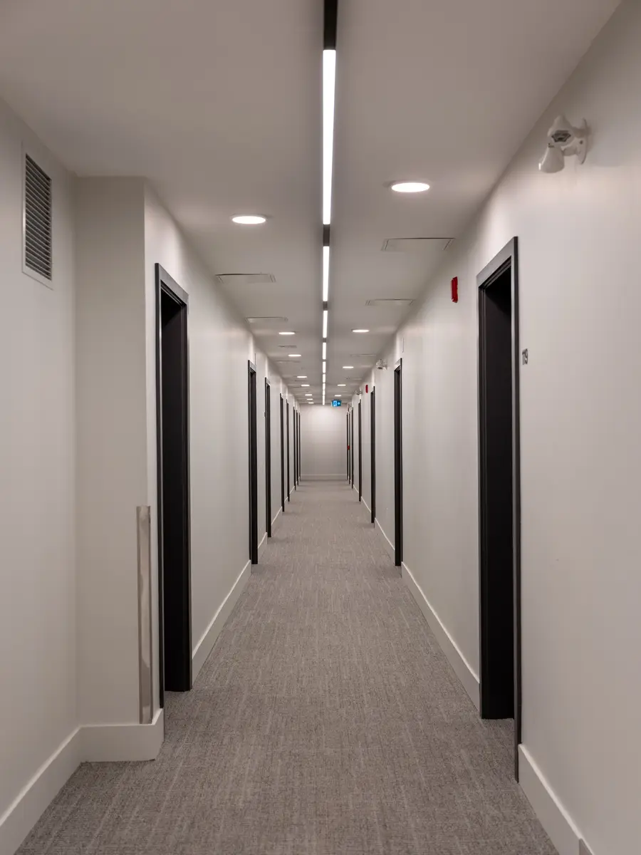 A long corridor of dark doors