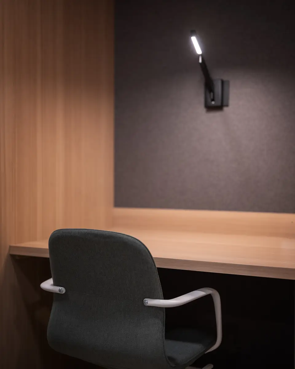 A wood desk, a chair, and a reading light