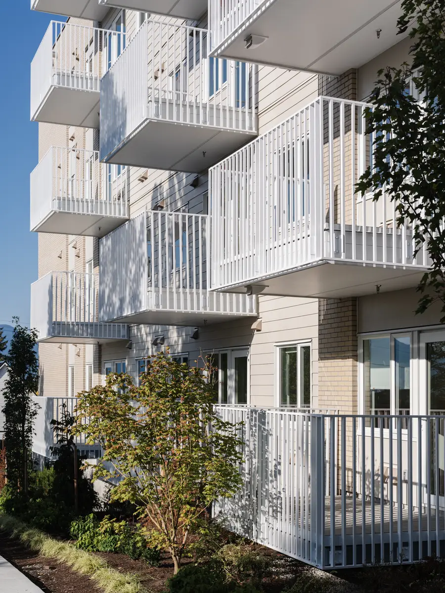 Looking up the courtyard elevation, balconies and a white fence
