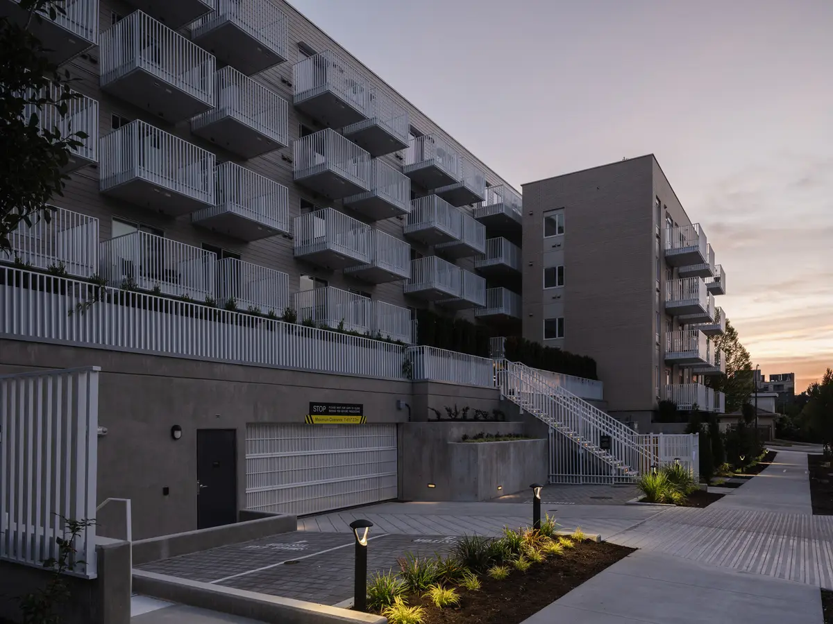 The drive and open stair at dusk, path lights on