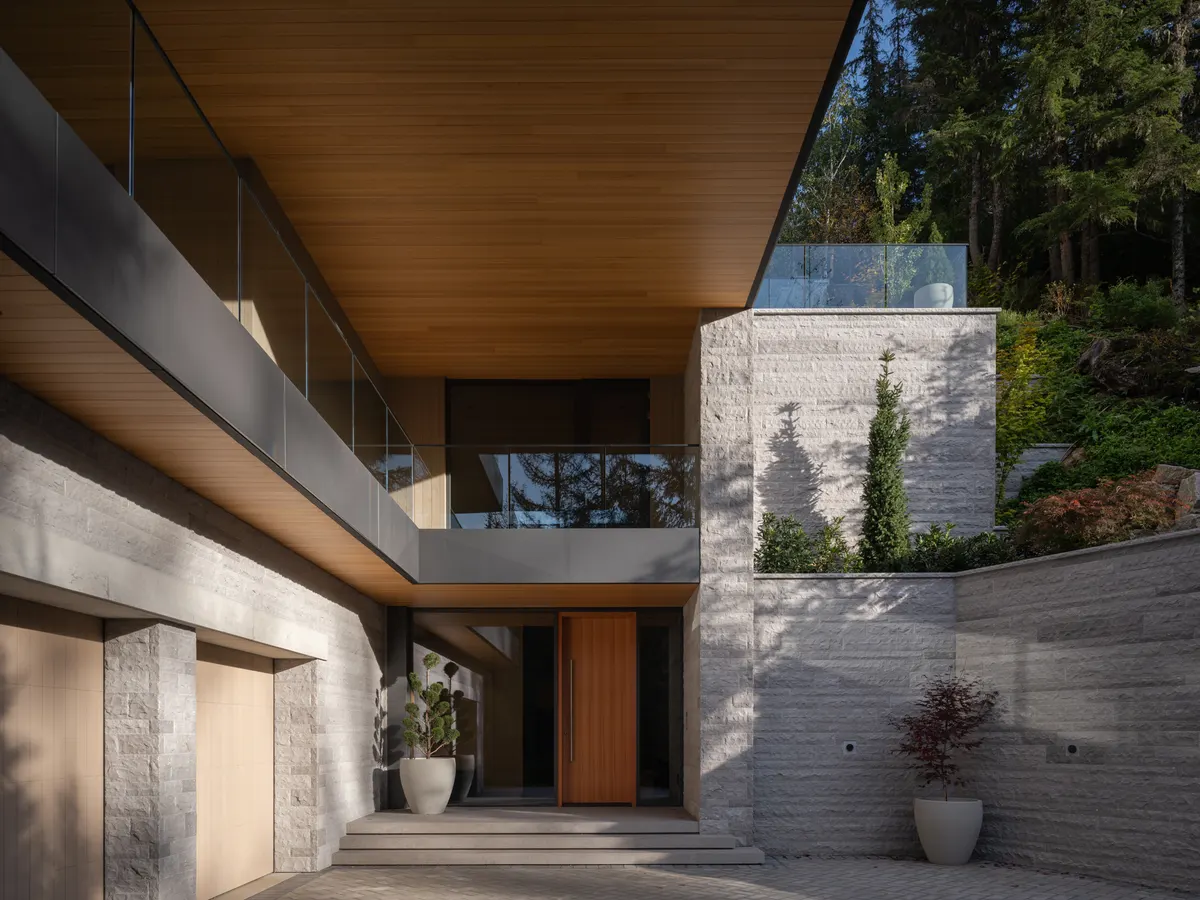 The arrival court, a wood door between stone walls, Panorama Ridge, Whistler