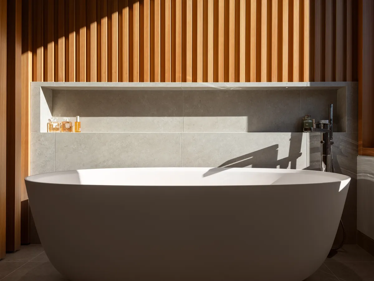 A freestanding tub against a wood-slat wall, Panorama Ridge, Whistler