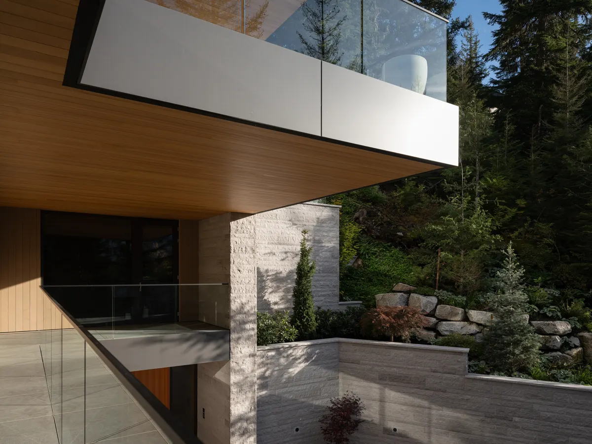 The corner of the cantilevered deck, stone and glass above the trees, Panorama Ridge, Whistler