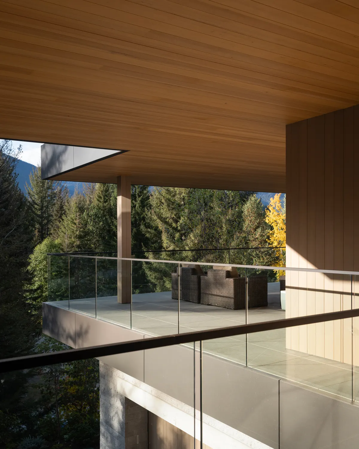 Under the wood soffit of the deck, a lounge and the trees beyond, Panorama Ridge, Whistler