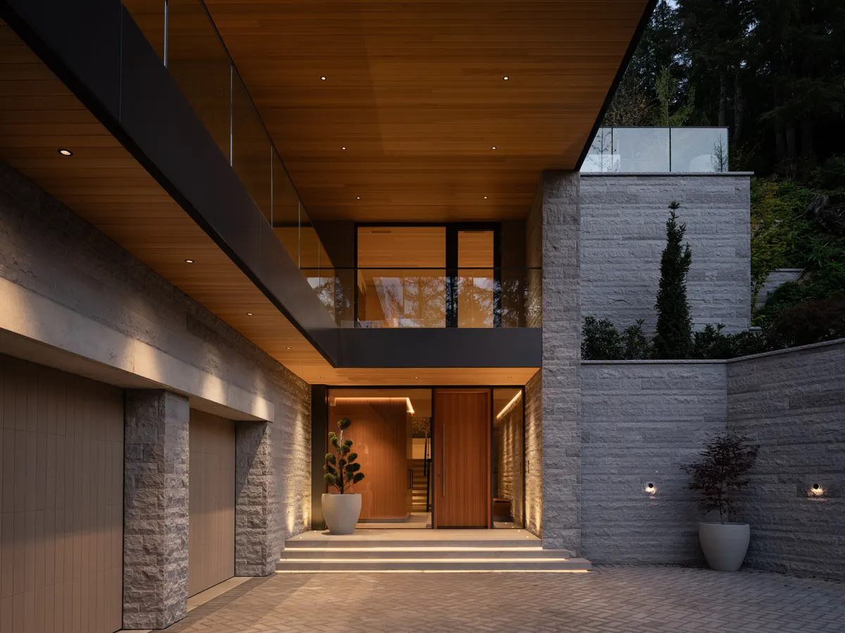 The arrival court at dusk, the entry lit, Panorama Ridge, Whistler