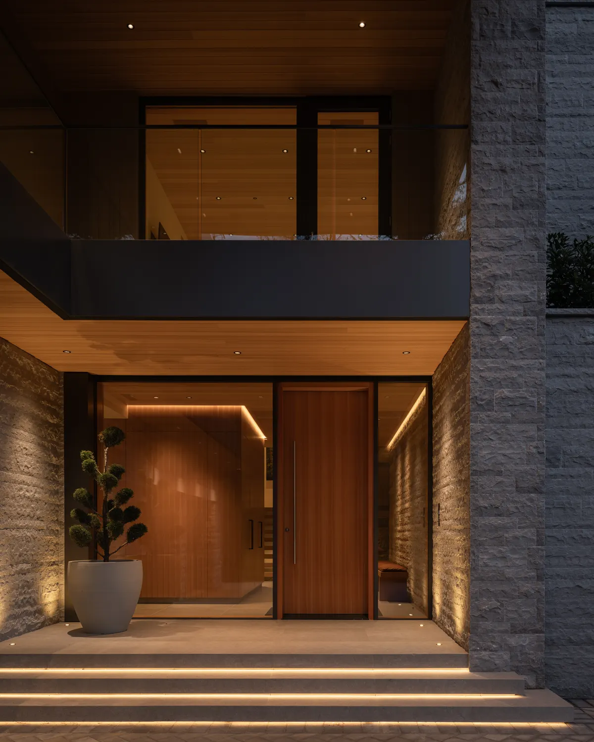 The entry at dusk, lit steps up to the wood door, Panorama Ridge, Whistler