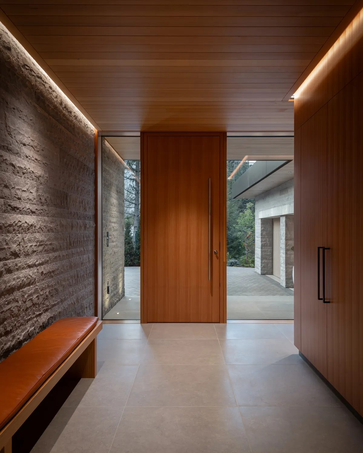 A bench in the entry, a wood door ahead, Panorama Ridge, Whistler
