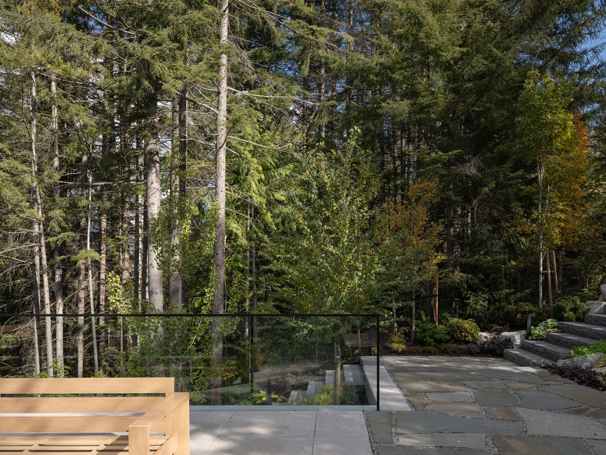 A flagstone terrace and the forest, a bench at the left, Panorama Ridge, Whistler