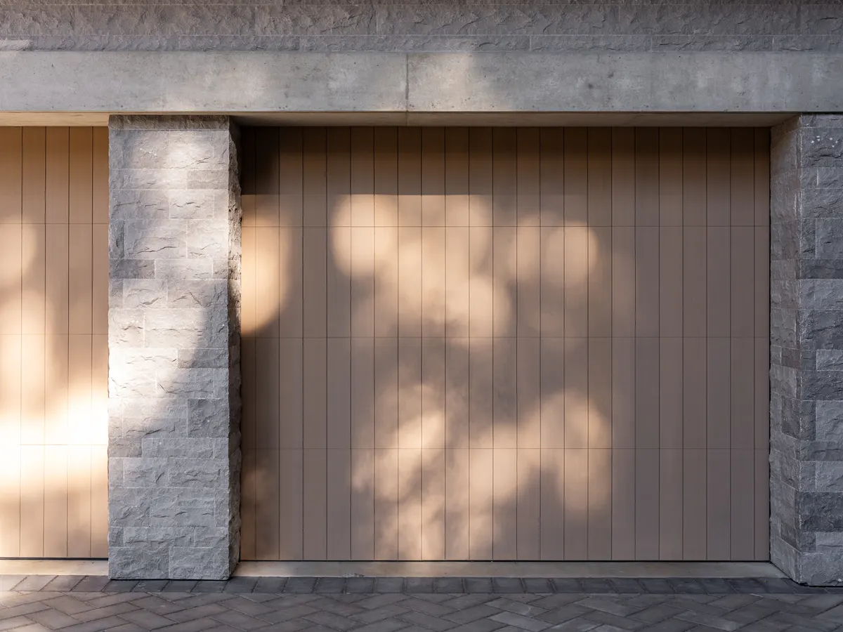 A wood garage door between stone piers, Panorama Ridge, Whistler