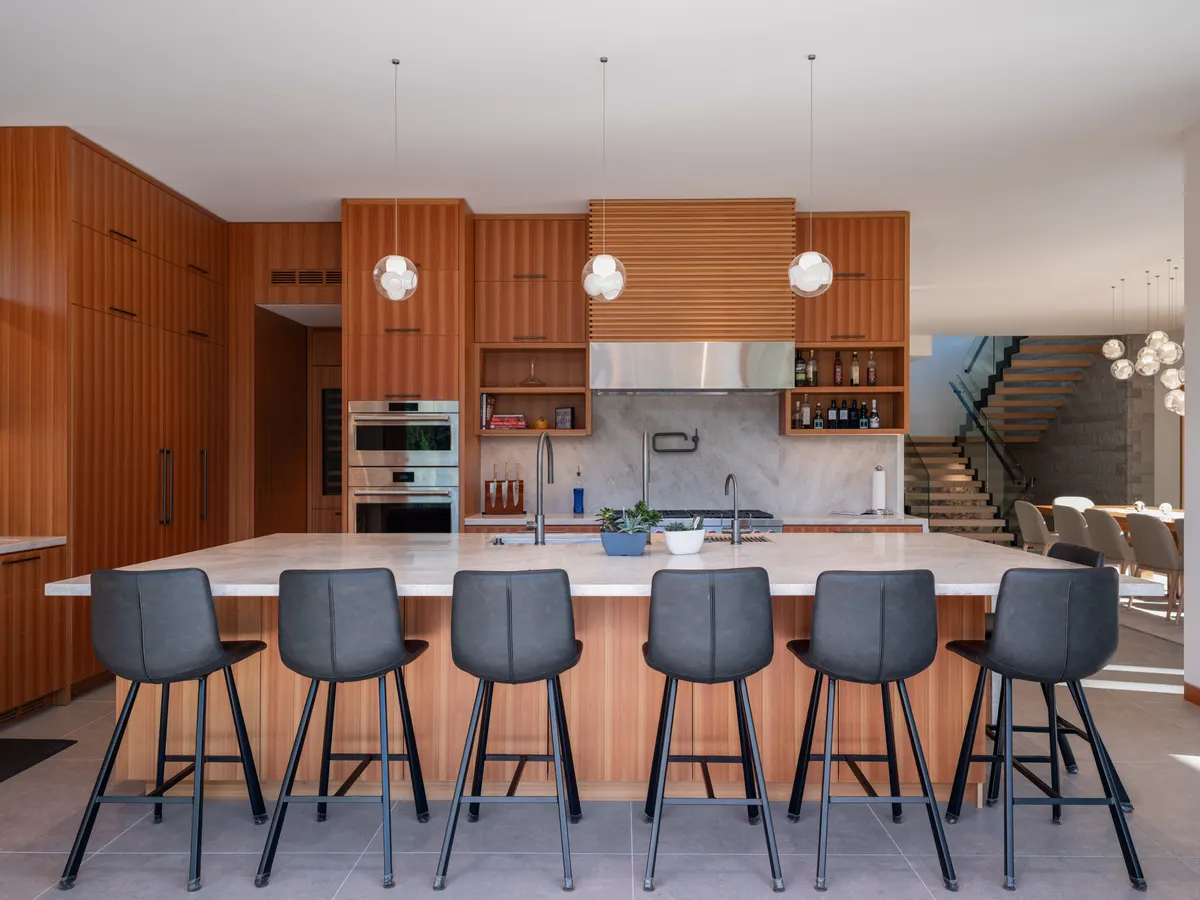 The kitchen island with stools, the dining table beyond, Panorama Ridge, Whistler