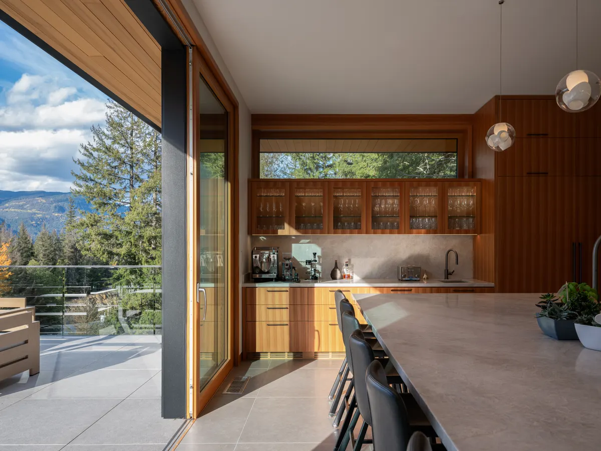 The kitchen island opening to the deck, Panorama Ridge, Whistler