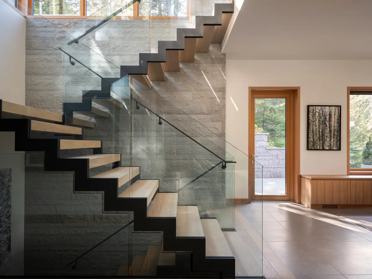 A stair with a glass guard, and a door to the trees, Panorama Ridge, Whistler