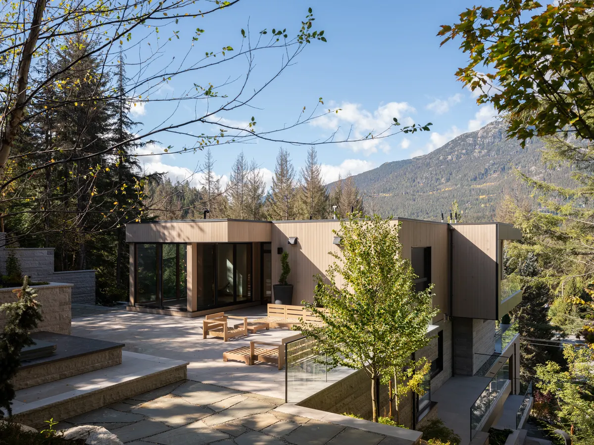 The upper terrace, loungers, the house, and the mountain behind, Panorama Ridge, Whistler