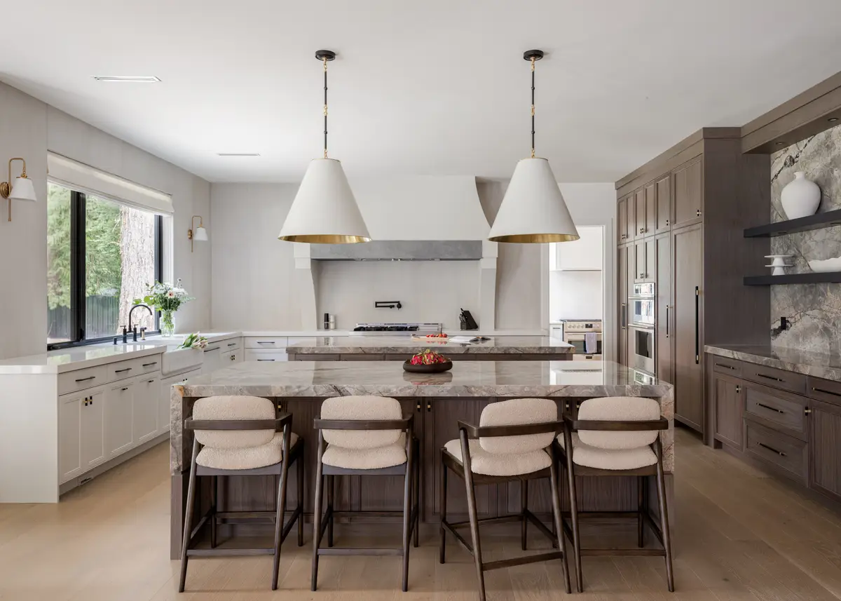 The kitchen island, wood cabinets, and stools