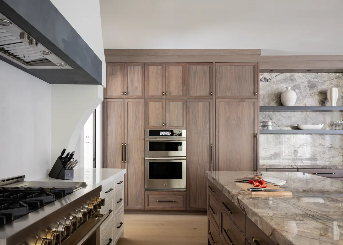 The range and hood between wood cabinets