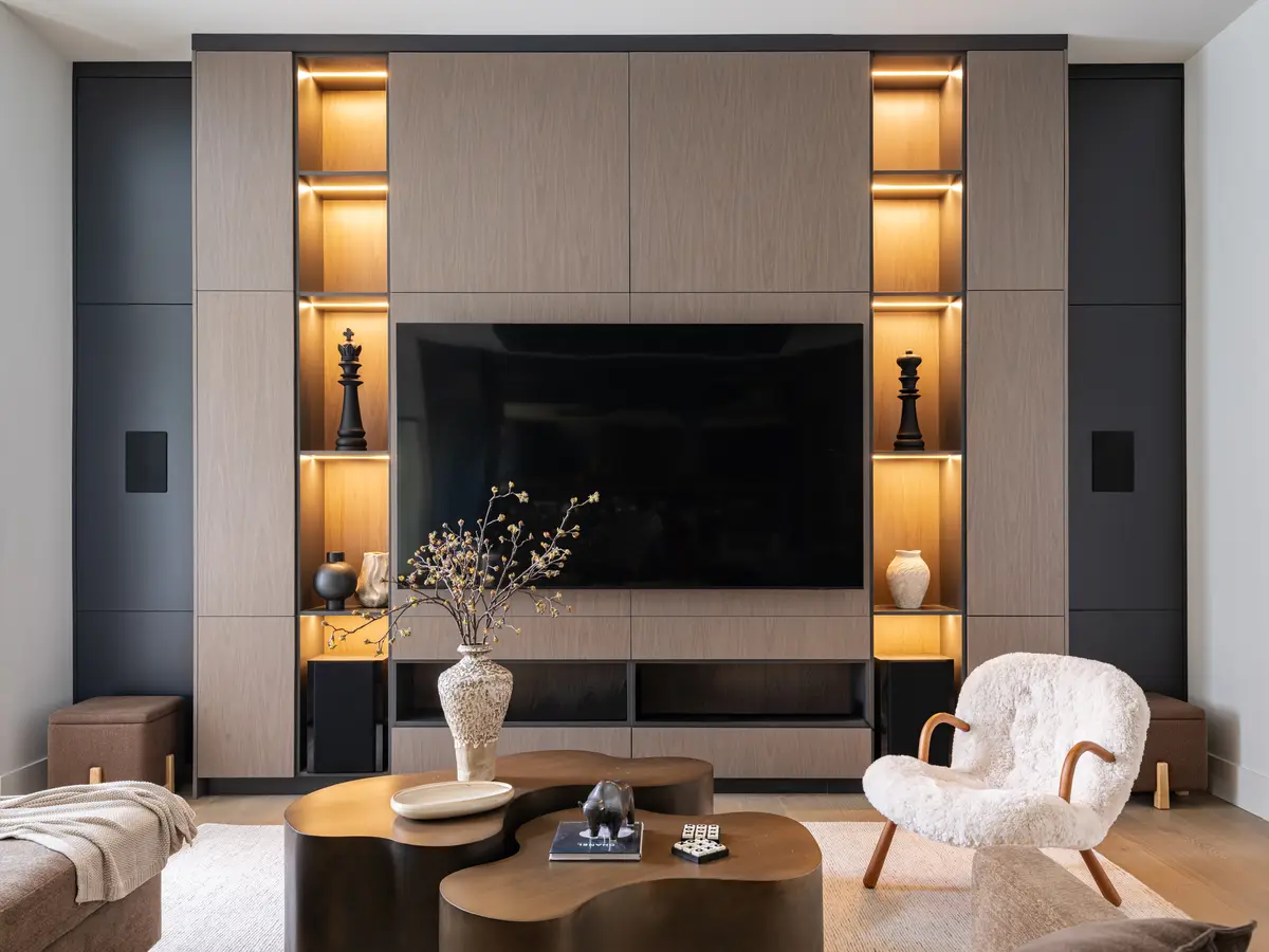 A media wall with lit shelves on either side of the screen