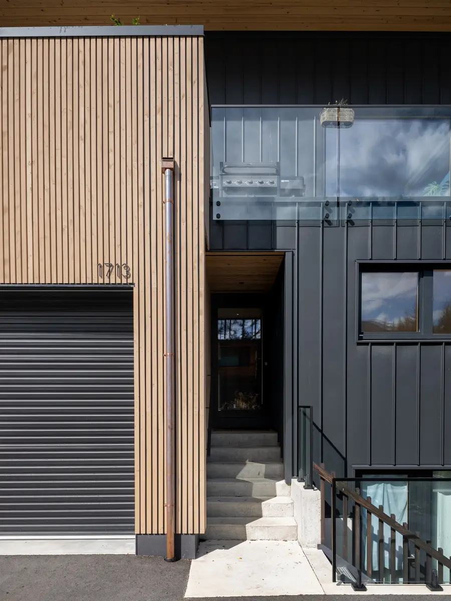 Entry at Riverrun Place, Whistler, the house number on the vertical wood beside the roll-up garage door