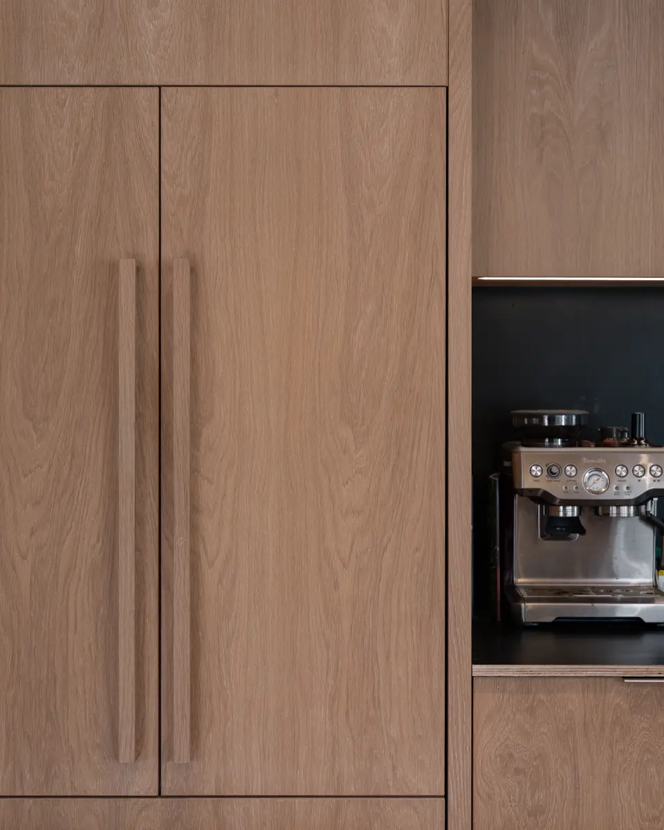 Panelled fridge doors and the espresso machine on the counter at Riverrun Place, Whistler