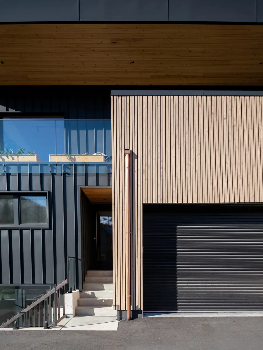 Garage and the entry, vertical wood and black metal, Riverrun Place, Whistler