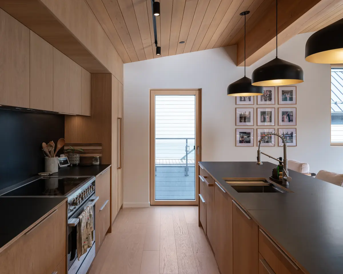 Kitchen range and a door to the deck at Riverrun Place, Whistler