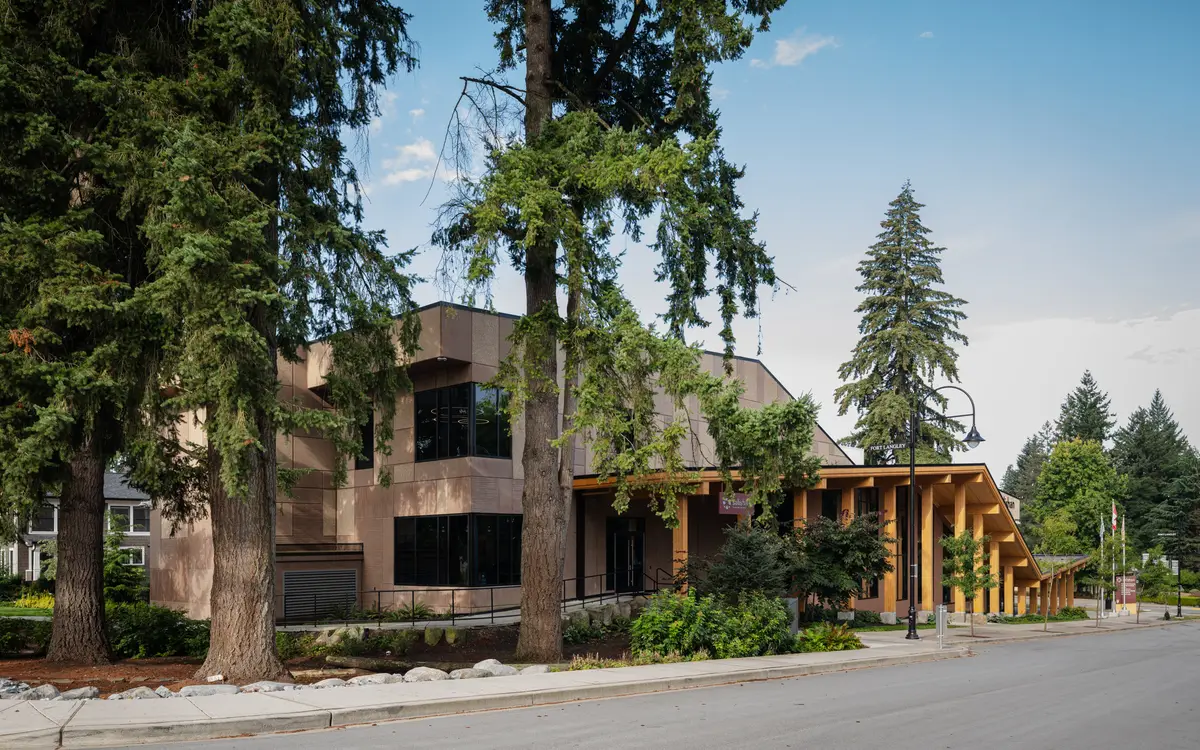 The street colonnade, timber columns under a long roof, trees behind
