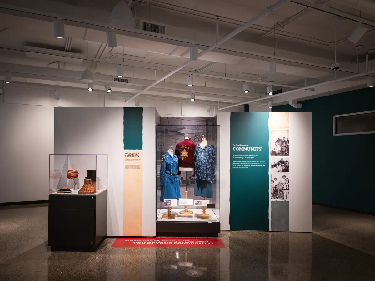 A gallery with a lit vitrine and cases along the wall