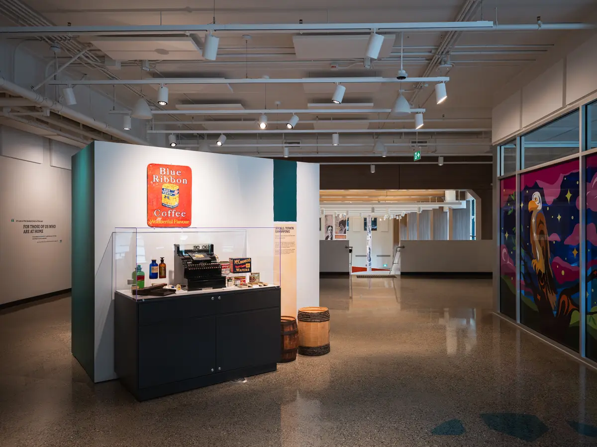The gallery, display cases and a red artwork on the far wall