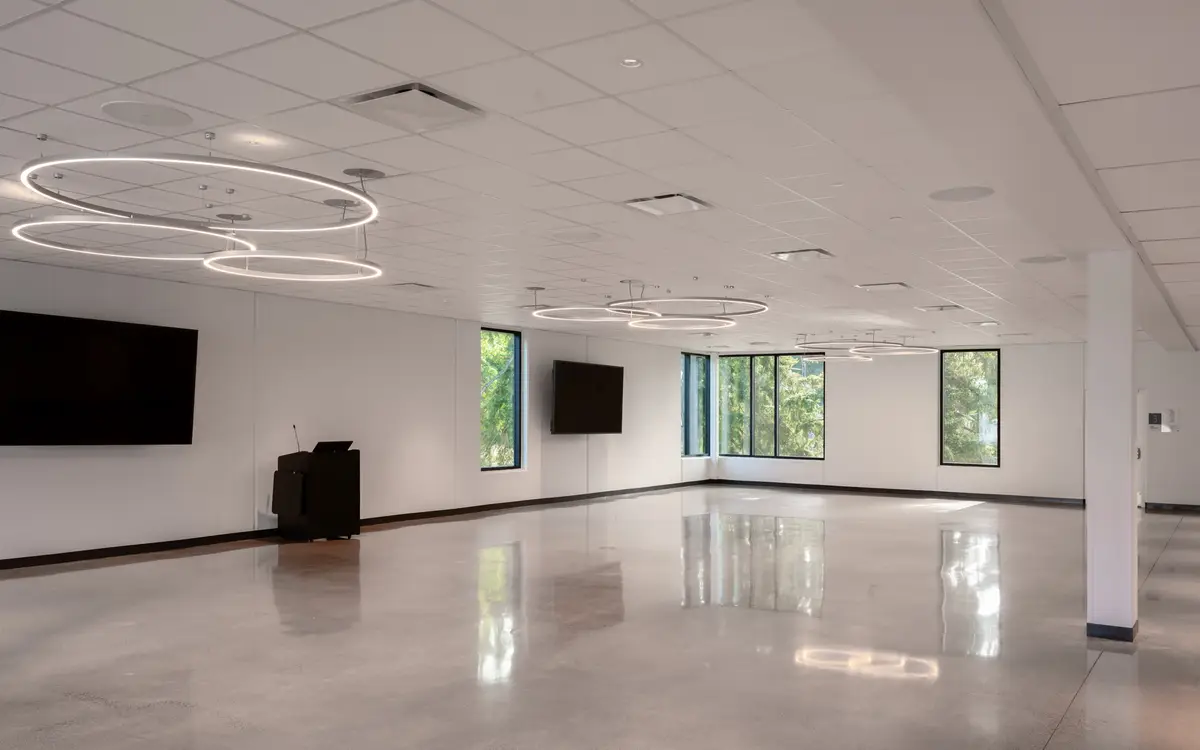 An empty hall, polished floor and a line of windows