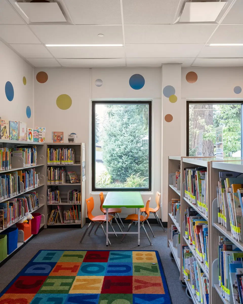 Bookshelves, a small table, and coloured circles on the wall